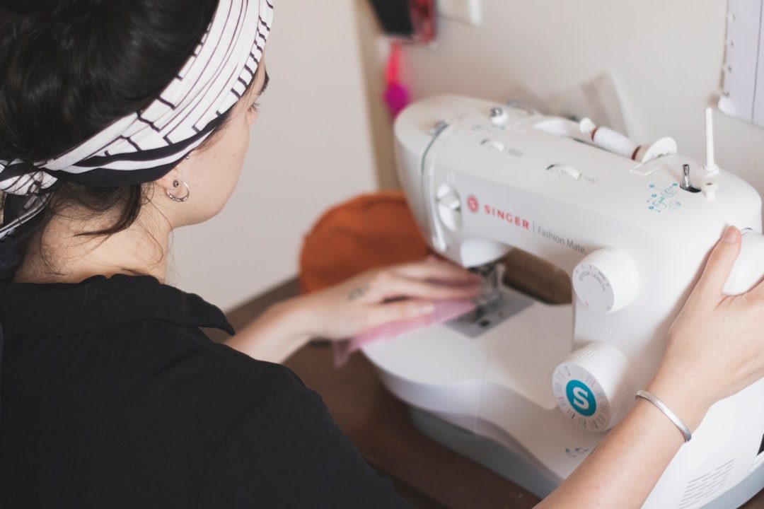 woman in black long sleeve shirt sewing